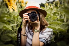woman taking photo of plants